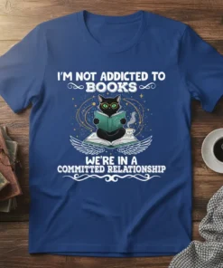 T-shirt with text "I'm Not Addicted To Books We're In A Committed Relationship" featuring a black cat reading a book