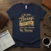 Gold text "I'm Not Bossy I Just Know What You Should Be Doing" on a navy blue t-shirt, featuring a