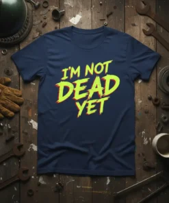 I'm Not Dead Yet quote in distressed yellow and red font on a navy t-shirt