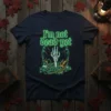 Navy t-shirt with neon green text "I'm not dead yet" and a skeleton hand rising from a cracked grave graphic