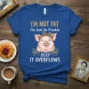 Blue t-shirt with "I'm Not Fat I'm Just So Freekin Sexy It Overflows" text and a smiling pig wearing a
