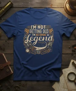 I'm Not Getting Old I'm Becoming A Legend quote on a blue t-shirt, featuring vintage engine parts and typography