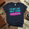 T-shirt with "I'm Not Like Most Teens I'm In My 40s" text in teal and pink on a navy blue