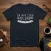 I'm Not Like Most Teens I'm In My 50's quote on a dark t-shirt, featuring retro typography and a banner