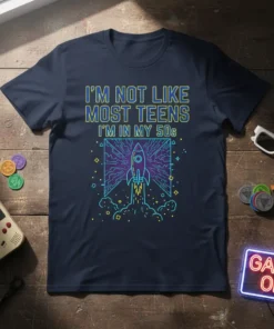 I'm Not Like Most Teens I'm In My 50s text with retro rocket graphic on a navy t-shirt