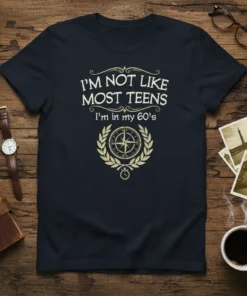 I'm Not Like Most Teens I'm In My 60's quote on a navy t-shirt with compass graphic