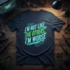 I'm Not Like The Others, I'm Worse quote t-shirt with neon green and blue typography and gear graphics