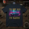 I'm Not Old I'm Classic quote on a navy t-shirt with a vibrant classic muscle car graphic and neon city
