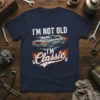 I'm Not Old I'm Classic text with a vintage muscle car graphic and flames on a navy t-shirt