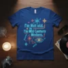 I'm Not old. I'm Mid Century Modern. text with retro starbursts and eye graphic on a blue t-shirt