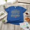 Royal blue t-shirt with gold glitter text "I'm Not Retired I'm A Full-Time Grandma" and a pink heart graphic