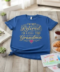 Royal blue t-shirt with gold glitter text "I'm Not Retired I'm A Full-Time Grandma" and a pink heart graphic