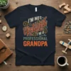 I'm Not Retired I'm A Professional Grandpa text design with gears and wrench graphic on a navy t-shirt