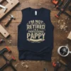 I'm Not Retired I'm A Professional Pappy quote on a navy blue sleeveless t-shirt, with distressed typography and a banner
