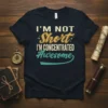 Retro graphic tee with the text "I'M NOT Short I'M CONCENTRATED Awesome" in vintage fonts and colors