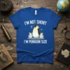 Blue t-shirt with "I'm Not Short I'm Penguin Size" text and a graphic of a large penguin with two smaller