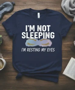 Navy t-shirt with white text "I'm Not Sleeping I'm Resting My Eyes" and a graphic of closed eyes with gold