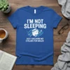 I'm Not Sleeping Just Checking My Eyelids For Holes text design on a blue t-shirt with a sleeping face graphic