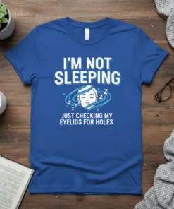 I'm Not Sleeping Just Checking My Eyelids For Holes text design on a blue t-shirt with a sleeping face graphic
