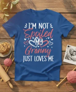 I'm Not Spoiled My Granny Just Loves Me text on a blue t-shirt with heart graphics, white and pink font