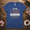 I'm Not Spoiled My Husband Just Loves Me text design on a royal blue t-shirt with decorative hearts and swirls