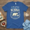 Blue t-shirt with "I'm Not Spoiled My Nonna Just Cloves Me" text and a polar bear with cub graphic, surrounded