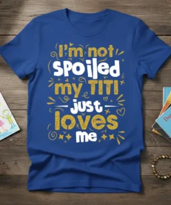 I'm not spoiled my TITI just loves me quote on a royal blue t-shirt, featuring white and gold glitter typography