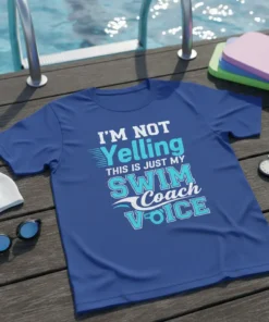 T-shirt with "I'm Not Yelling This Is Just My Swim Coach Voice" in bold blue and white typography, designed for