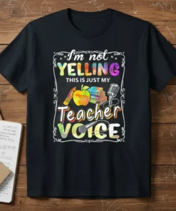 I'm not YELLING THIS IS JUST MY Teacher VOICE quote on a black t-shirt with colorful text and school-related graphics