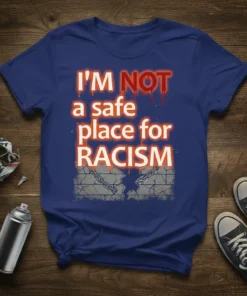 Bold typography reads "I'M NOT a safe place for RACISM" with cracked brick wall and chains graphic on a blue