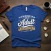 Blue t-shirt with white and yellow text "I'm often mistaken for an adult because of my age" in a fun