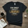 Christian t-shirt with "I'm Only Talking To Jesus Today" text in vintage distressed font, featuring a small cross