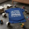 Blue t-shirt with white text: "I'm Proof Therapy Works But I'll Still Knock All This Stuff Over" quote design