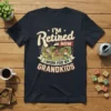 I'm Retired NOW I WORK FOR MY GRANDKIDS t-shirt with colorful illustration of children playing on a playground