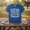 "I'm Retired You're Not Have Fun At Work Tomorrow" quote on a blue t-shirt, with white distressed typography and decorative