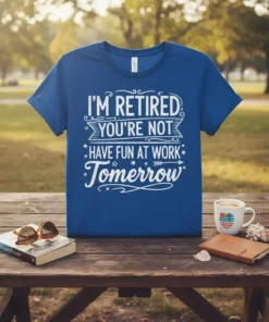 "I'm Retired You're Not Have Fun At Work Tomorrow" quote on a blue t-shirt, with white distressed typography and decorative