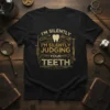 Black t-shirt with gold text "I'm Silently Judging Your Teeth" and dental tools graphics