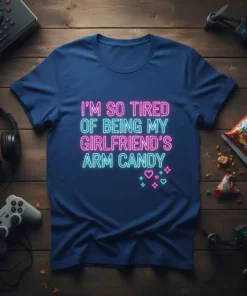 Neon text design "I'm So Tired Of Being My Girlfriend's Arm Candy" on a navy blue t-shirt, featuring pink and