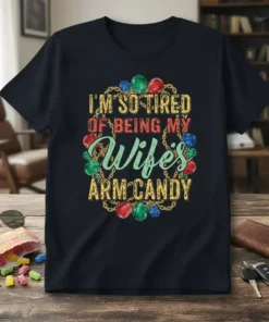 I'm So Tired Of Being My Wife's Arm Candy quote with colorful gemstones and gold chain graphic on a black