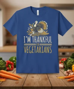 I'm Thankful For Vegetarians t-shirt with a graphic of a turkey on corn and autumn leaves. The text is in