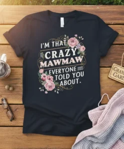 T-shirt with white text "I'm That Crazy Mawmaw Everyone Told You About" surrounded by pink flowers and green leaves