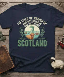T-shirt design with text "I'm Tired of Waking Up and Not Being In and Not Being" above a Highland cow