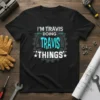 Black t-shirt with white and turquoise text reading "I'M TRAVIS DOING TRAVIS THINGS" inside a gear graphic