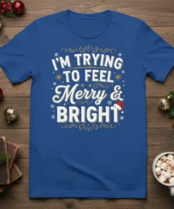 Blue t-shirt with white and gold text that reads "I'm Trying To Feel Merry & Bright" in festive holiday font