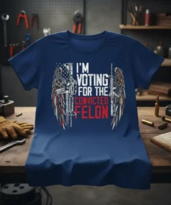 T-shirt with "I'm Voting For The Convicted Felon" text, American flag, wings, and firearms graphic