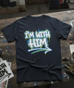 Graffiti-style "I'm With Him" text design with a blue and yellow arrow on a navy t-shirt