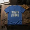Blue t-shirt with "I'M WITH STOOPID" text in distressed cream font and a black arrow pointing upwards