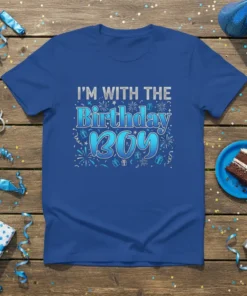 Blue t-shirt with "I'M WITH THE Birthday BOY" text in silver and blue gradient, surrounded by confetti and gift graphics