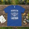 I'm With The Ladybug t-shirt design with a detailed white ladybug graphic and decorative border