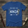 Blue t-shirt with white text "I'M WITH THE NINJA", gold dragon graphic, and ninja stars